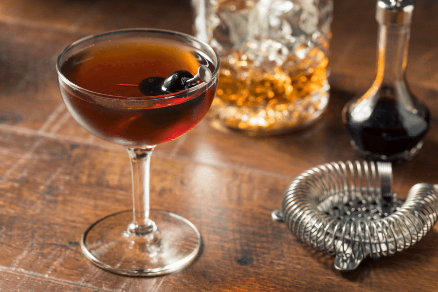 dark brown brooklyn cocktail with a maraschino cherry